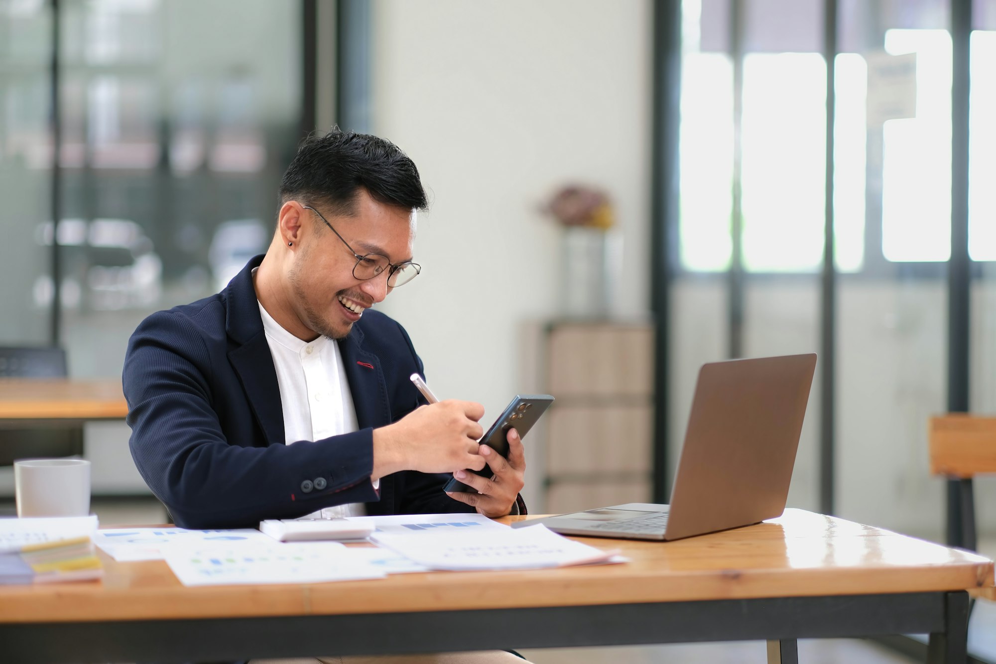 Portrait of a male business owner showing a happy smiling face as he has successfully invested his